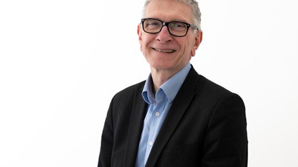Steve Partridge headshot wearing a shirt and suit jacket