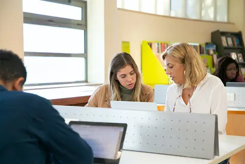 People At Desks With Computers