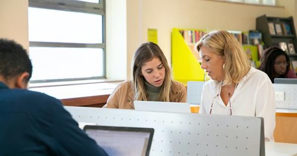 People At Desks With Computers