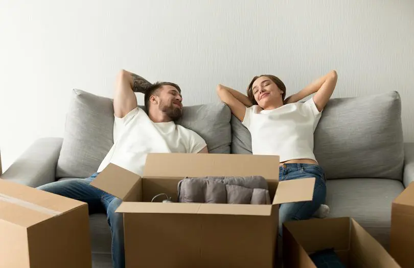 Woman and man lying down on a sofa