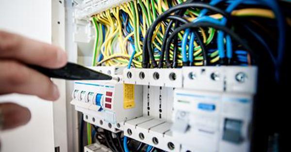 fingers pointing to a fuse box