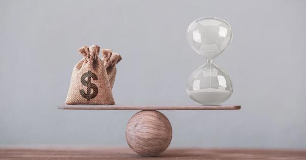 money balancing on ball with sand timer