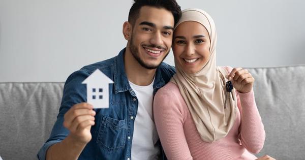 Couple On Sofa With Keys To New House 