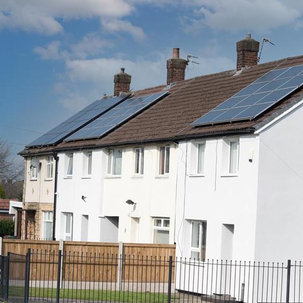 white houses in a row with solar panels