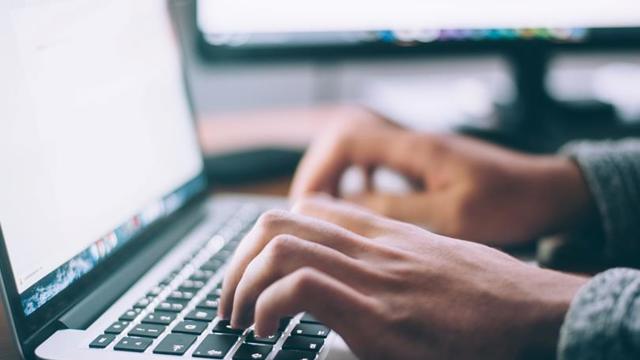 hands typing on laptop
