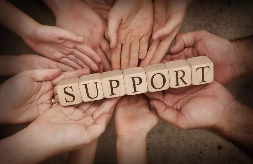 Support in letter text blocks surrounded by hands