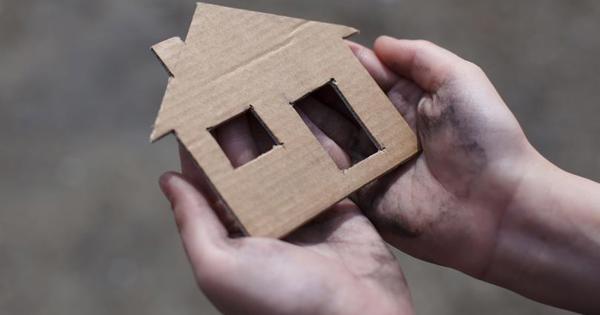 Hands Holding Cardboard House