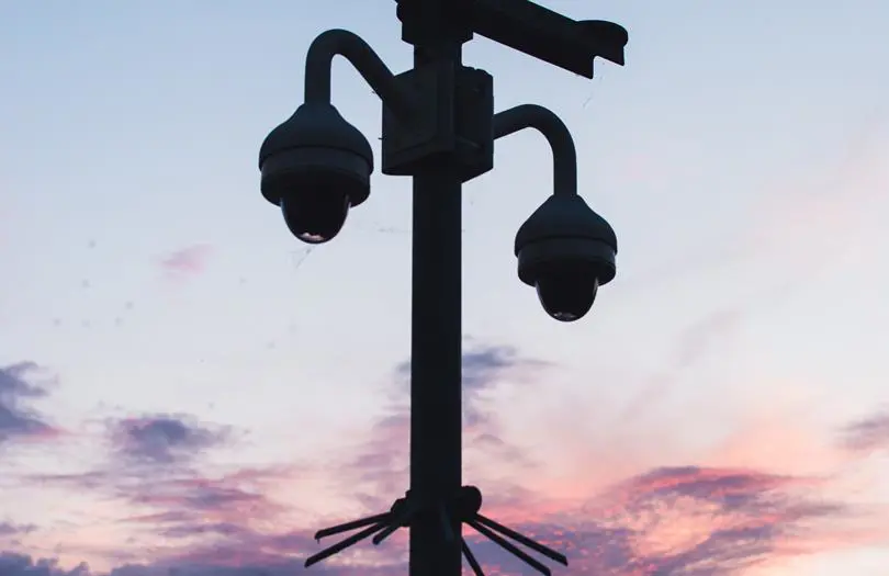 CCTV on a lamppost against the sky