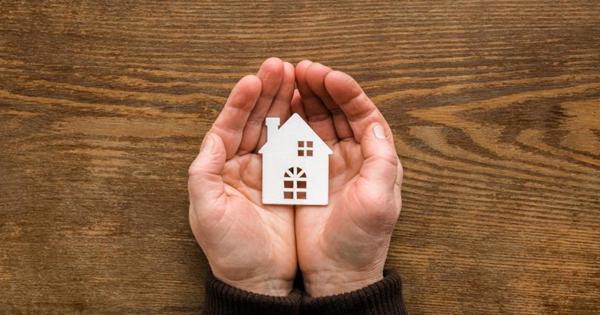 hands holding a small house icon