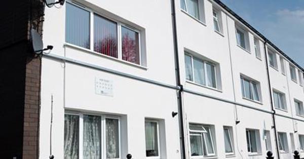White houses converted to flats with large windows