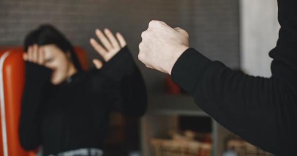woman shielding herself against a fist