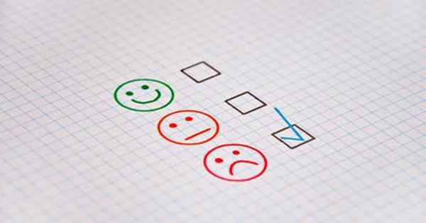 Happy neutral and sad faces on paper with a tick next to sad