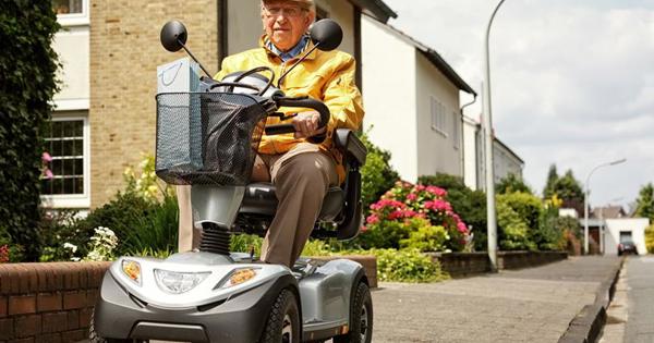 An older man on a Mobility Scooter on a street