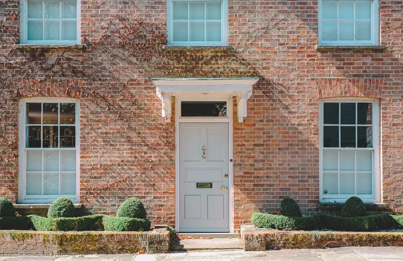 front view of a house with door and large windows