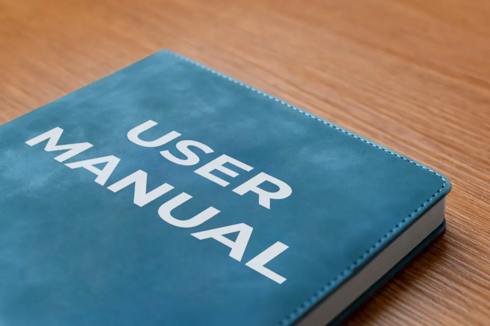 close up top half of a book in blue that says user manual on the front 