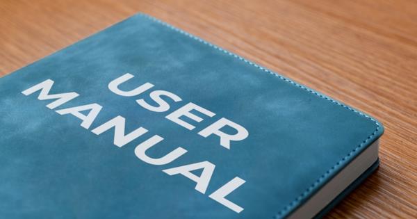 close up top half of a book in blue that says user manual on the front 