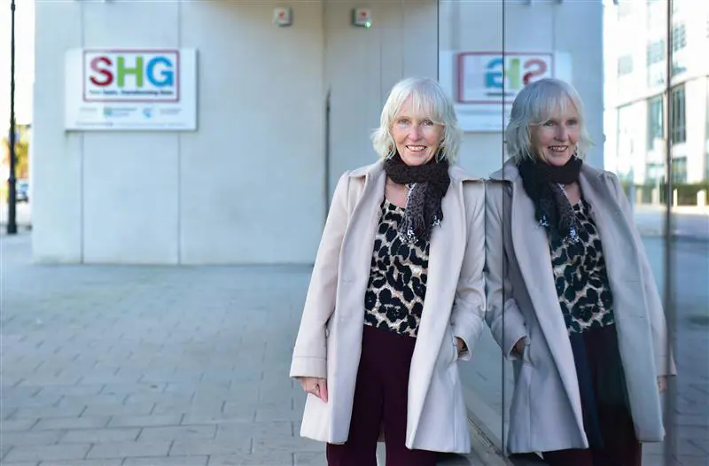 Helen Mchale in front of SHG office building 