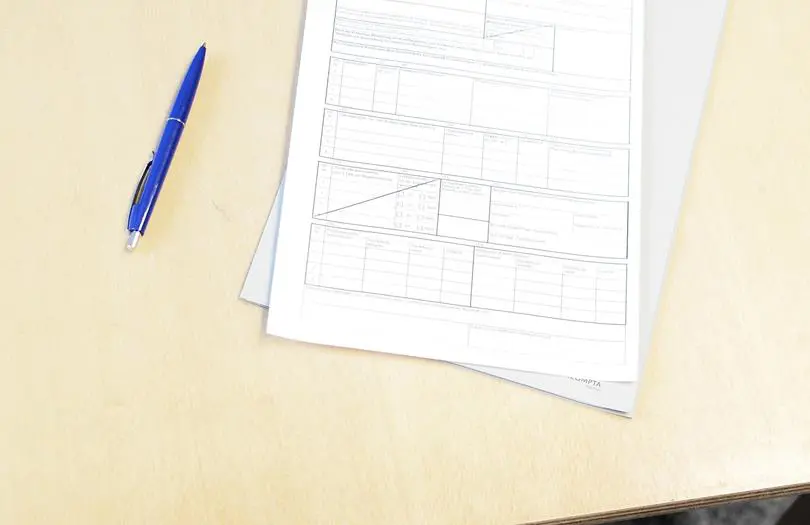 paper form on desk with pen to the side