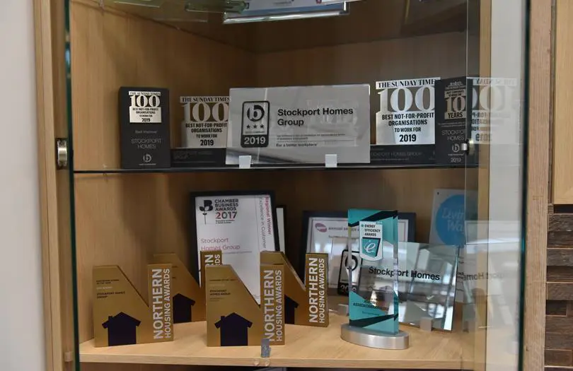 collection of awards in a trophy cabinet