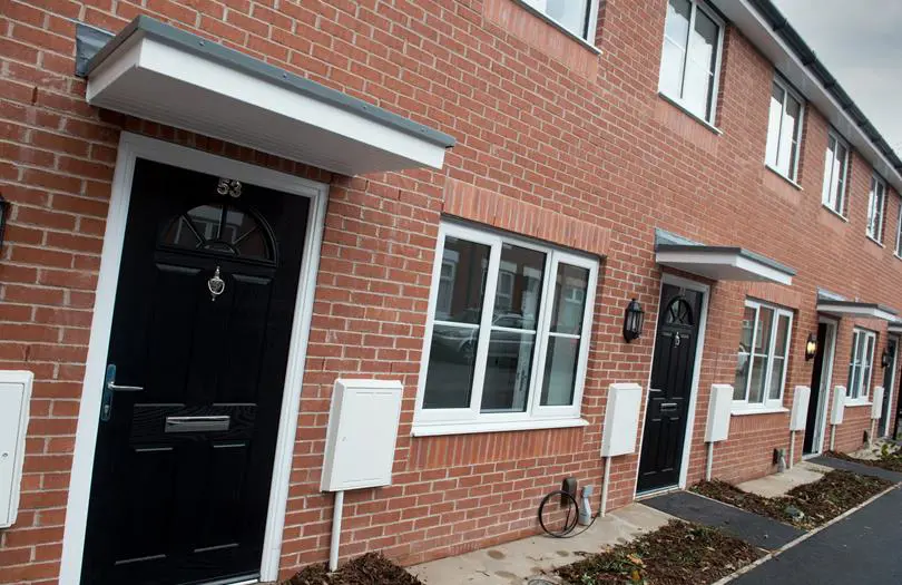 front view of a new build home with a black door