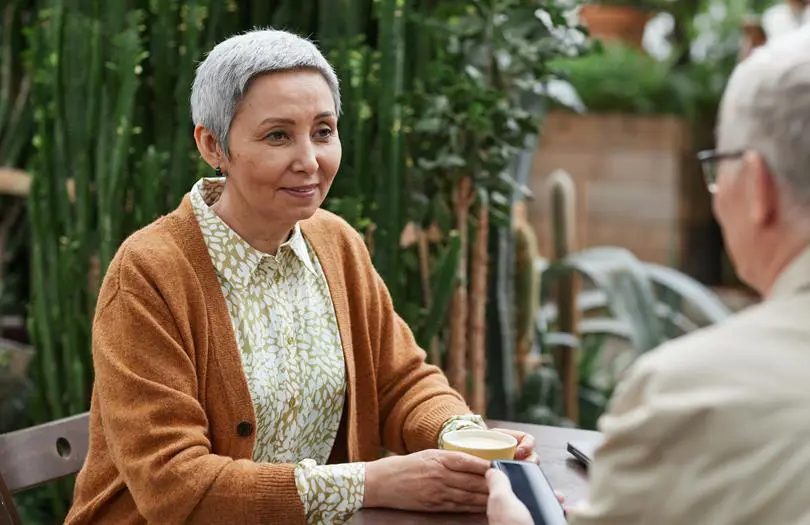 older woman speaking to man