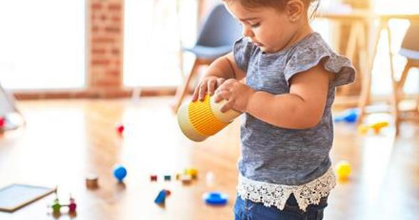 A child playing on her own in a bright room
