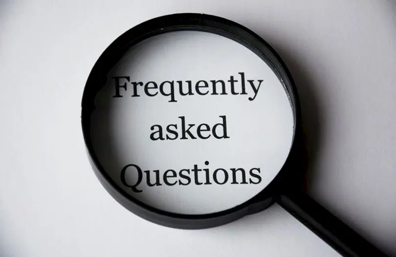 frequently asked questions text on paper with magnifying glass