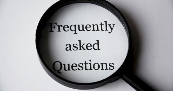 frequently asked questions text on paper with magnifying glass