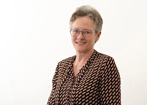 Headshot of Karen Mitchell wearing a dot shirt
