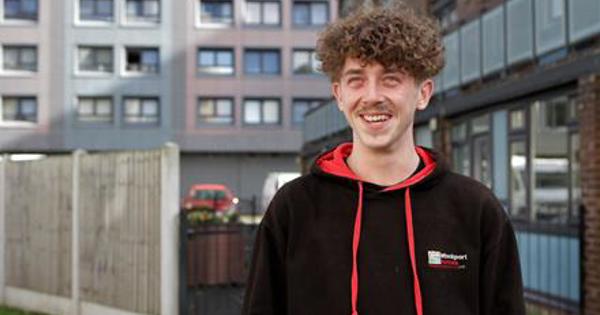 Caretaker smiling in front of tower block