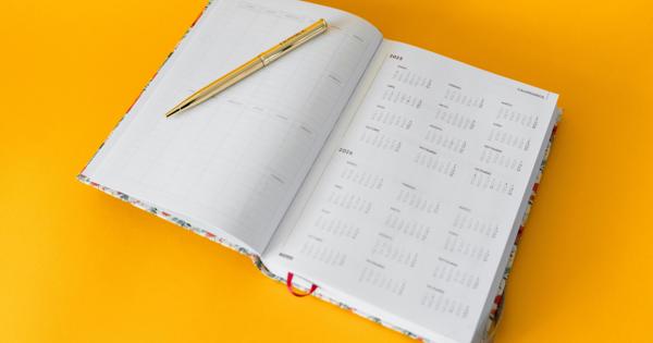A notebook of a Calendar against a orange background