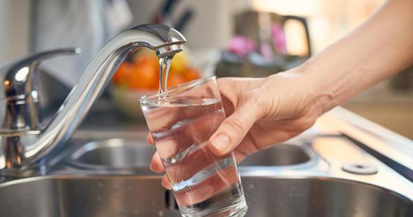 A hand filling up a glass of water from the tap