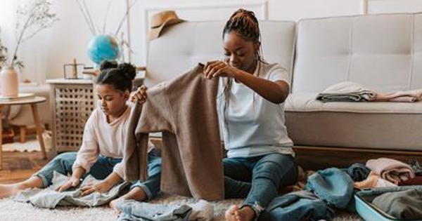 Woman and child sorting through clothes inside home